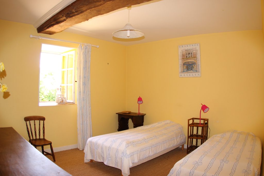 Yellow bedroom of La Ferme cottage at Château de Flottemanville