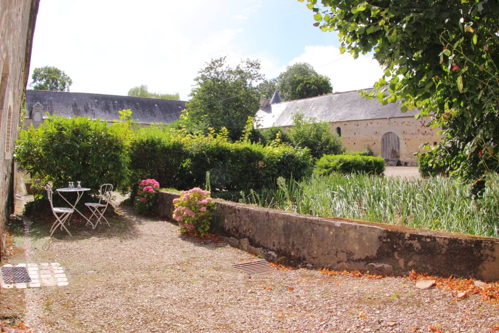Exterior of La Serre cottage at Château de Flottemanville, courtyard side